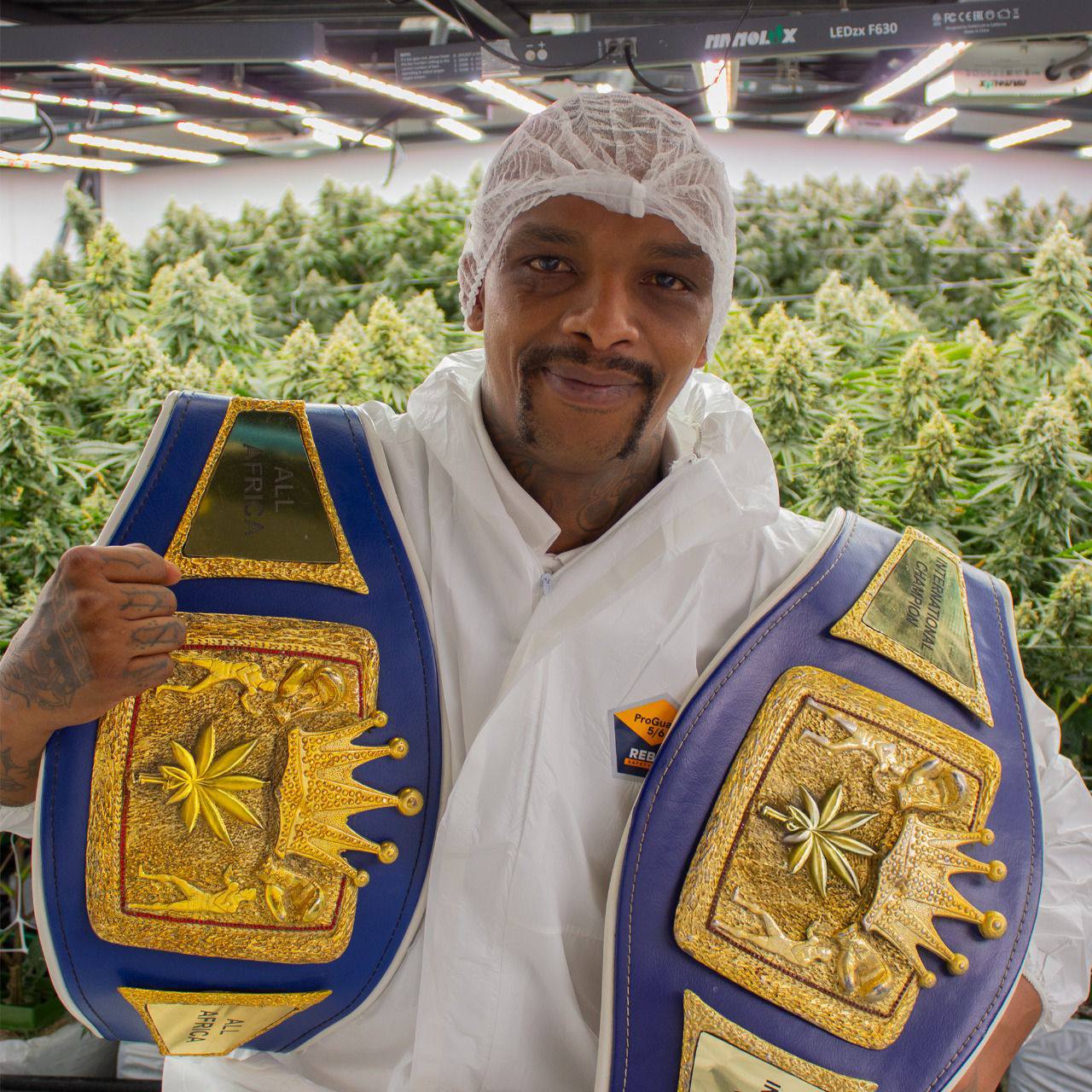 David Rajuili posing with championship belts