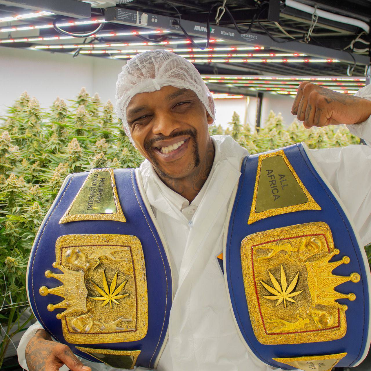 David Rajuili smiling with championship belts